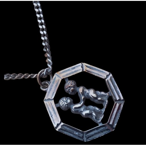 306 - A ZODIAC TWINS PENDANT ON CURB LINK CHAIN