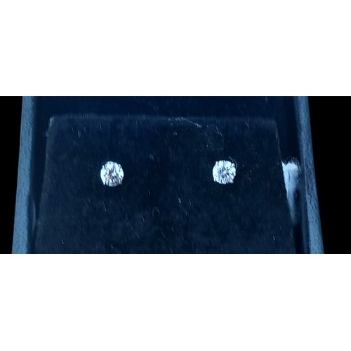 683 - A NEW PAIR OF 9ct WHITE GOLD DIAMOND (0.25ct) STUD EARRINGS