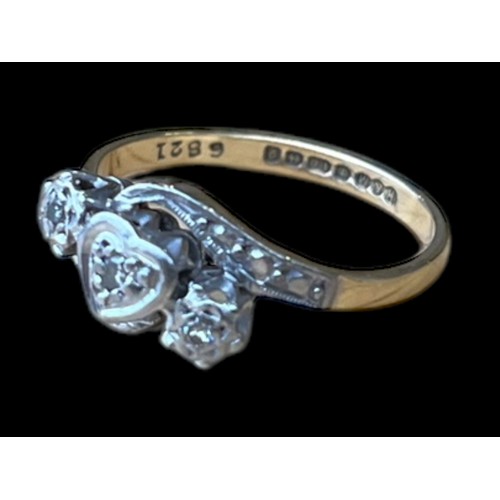 684 - AN 18CT GOLD DIAMOND RING WITH A HEART DESIGN