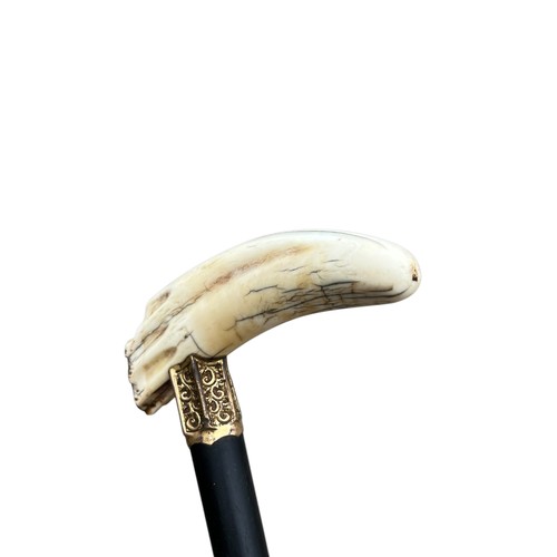 393 - AN ORNATE ELPHANT SEAL TOOTH EBONY SHAFTED WALKING STICK