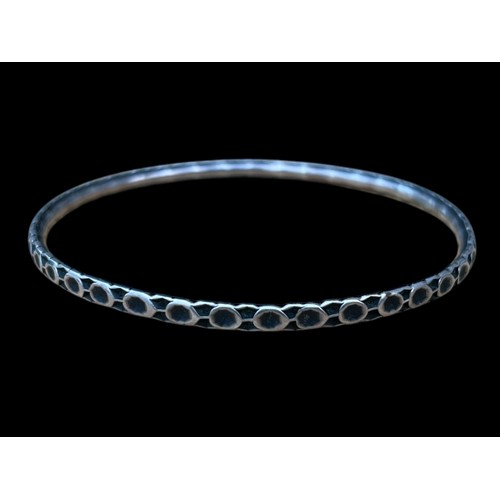 505 - AN ORNATE SILVER BANGLE