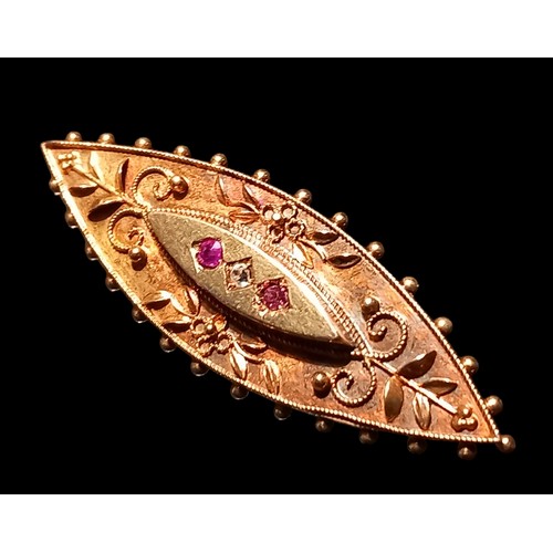 693 - A 14CT GOLD BROOCH SET WITH RUBIES