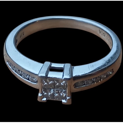 707A - A PLATINUM DIAMOND RING 4 PRINCESS CUT DIAMONDS TO CENTRE WITH 5 CHANNEL SET TO EACH SIDE IN PLATINU... 