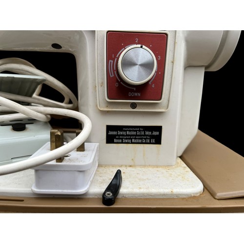 10 - A CASED VINTAGE SEWING MACHINE