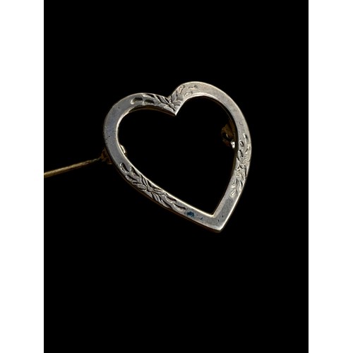 205 - AN ORNATE SILVER HEART BROOCH