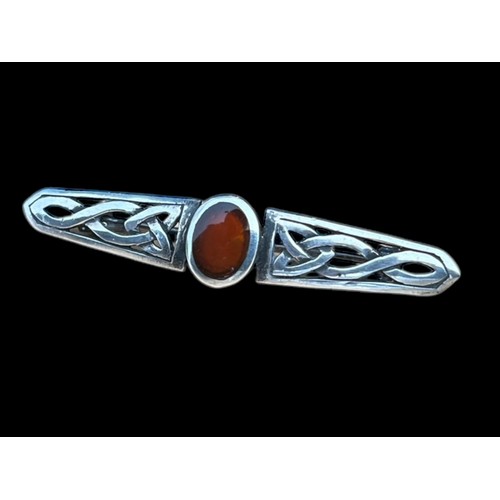 273 - A CELTIC SILVER BROOCH SET WITH CORNELIAN