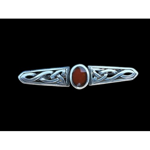 273 - A CELTIC SILVER BROOCH SET WITH CORNELIAN