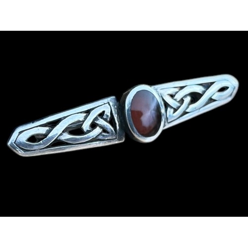 273 - A CELTIC SILVER BROOCH SET WITH CORNELIAN