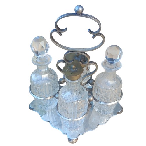 380 - AN ANTIQUE CUT GLASS CRUET SET PLATED BASE