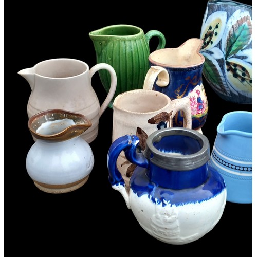 385 - A MIXED LOT OF POTTERY JUGS