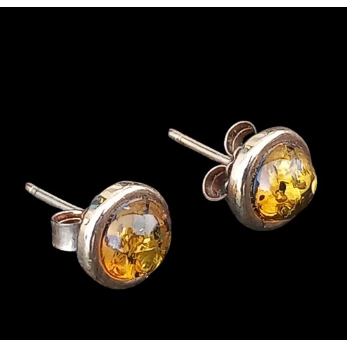 594 - A PAIR OF 9CT GOLD STUD EARRINGS WITH AMBER CENTRE