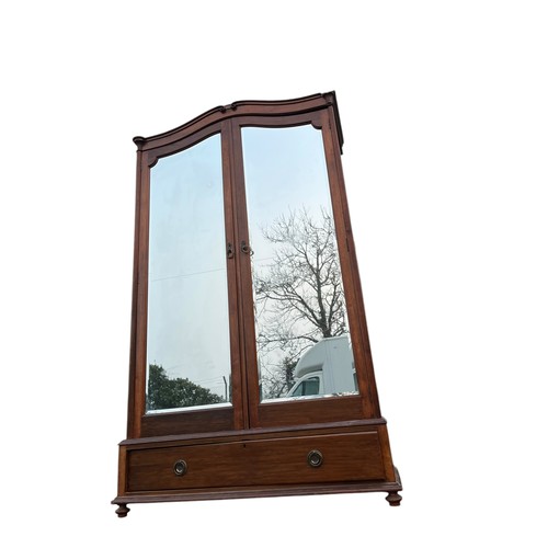 409 - A MAHOGANY SHAPED DOUBLE ROBE WITH MIRRORED DOORS