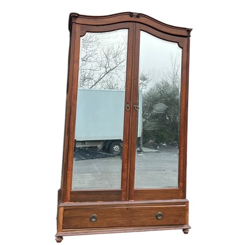 409 - A MAHOGANY SHAPED DOUBLE ROBE WITH MIRRORED DOORS