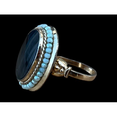 615 - A LARGE OVAL OYNX AND SEED PEARL RING IN 12K PLATED AND ADJUSTABLE SHANK WEIGHS 5.89G