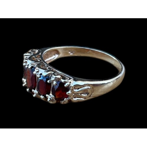 621 - A 9CT GOLD CHUNKY 5 STONE OVAL CUT GARNET SET RING WITH A CURVED MOUNT ON A HEAVY SHANK WEIGHS 4.30G