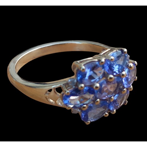 661 - A GOLD RING SET WITH 7 OVAL TANZANITE STONES IN CLAW SETTING WEIGH 4.27G SIZE T