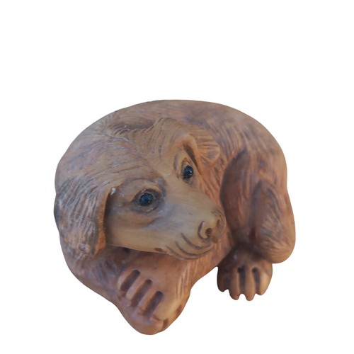 679 - A NETSUKE DOG WITH MARKINGS