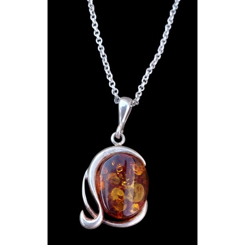 545 - A SILVER AND AMBER FOB ON SILVER CHAIN