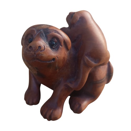 552 - A NETSUKE DOG WITH MARKINGS