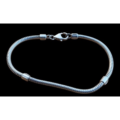 573 - A TUBE PATTERNED SILVER BRACELET WITH 4 BARREL AND GLASS CHARMS