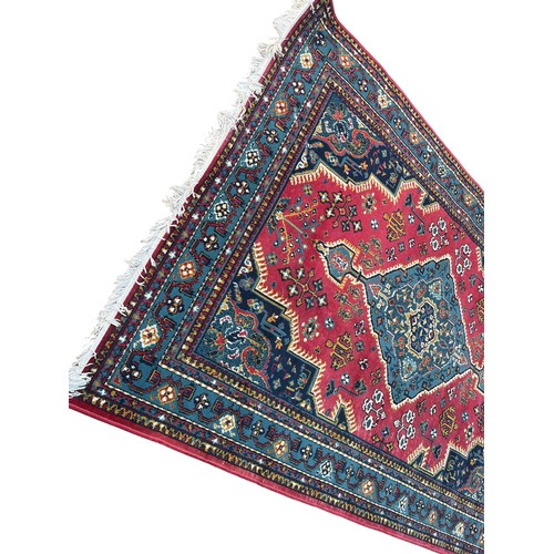 391 - A LARGE RED PATTERNED RUG