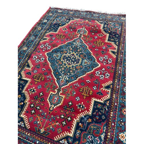 391 - A LARGE RED PATTERNED RUG