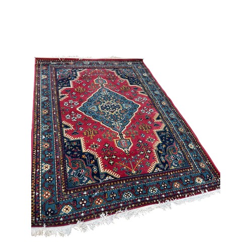 391 - A LARGE RED PATTERNED RUG