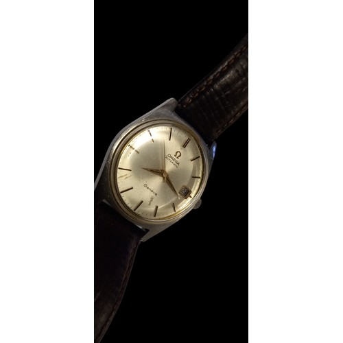 614A - AN OMEGA GENEVA WATCH WITH ORIGINAL LEATHER STRAP