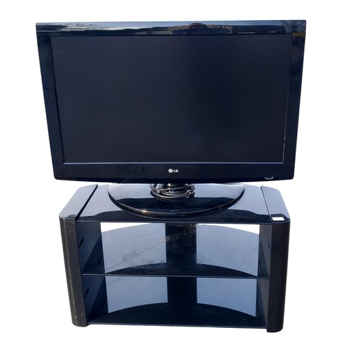 53 - AN LG TV ON STAND IN PWO