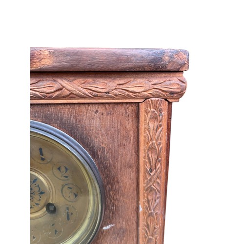 153 - AN OAK CARVED BRACKET CLOCK