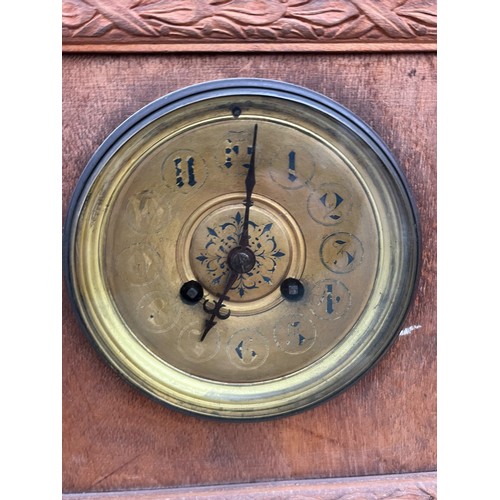 153 - AN OAK CARVED BRACKET CLOCK