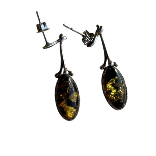 184 - AN ORNATE PAIR OF DROP SILVER EARRINGS WITH AMBER STONES