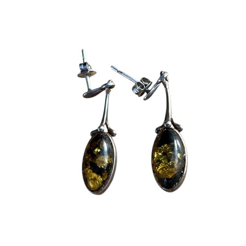 184 - AN ORNATE PAIR OF DROP SILVER EARRINGS WITH AMBER STONES