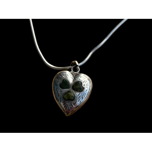 244 - AN ORNATE SILVER HEART PENDANT SET WITH IRISIH CONNAMARA MARBLE ON A SILVER CHAIN