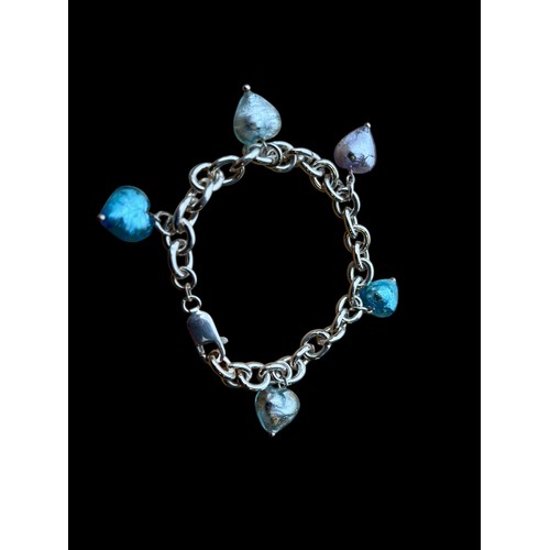 247 - A SILVER BRACELET  WITH  GLASS HEART SHAPE CHARMS