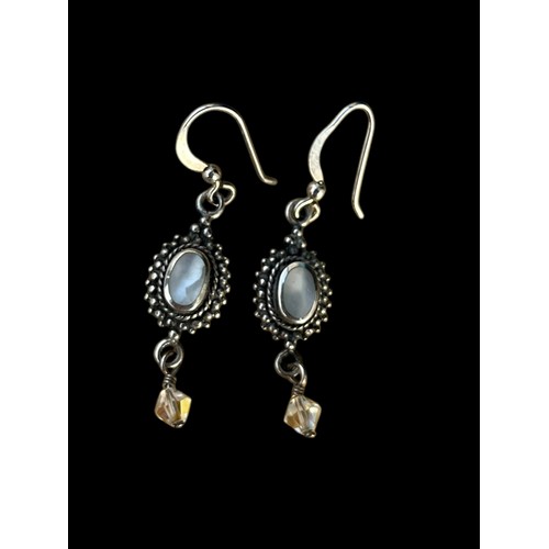 424 - AN ORNATE PAIR OF SILVER EARRINGS SET WITH MOONSTONE STYLE STONES