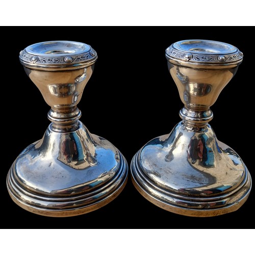 551 - A PAIR OF SILVER CANDLESTICK WITH A CELTIC BORDER