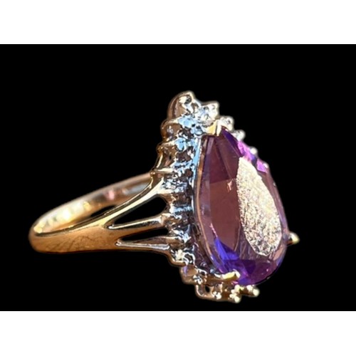 570 - A 9ct GOLD PEAR SHAPED AMETHYST AND DIAMOND CHIP RING