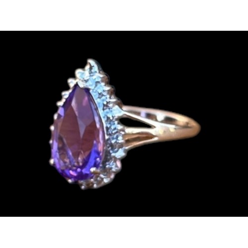 570 - A 9ct GOLD PEAR SHAPED AMETHYST AND DIAMOND CHIP RING