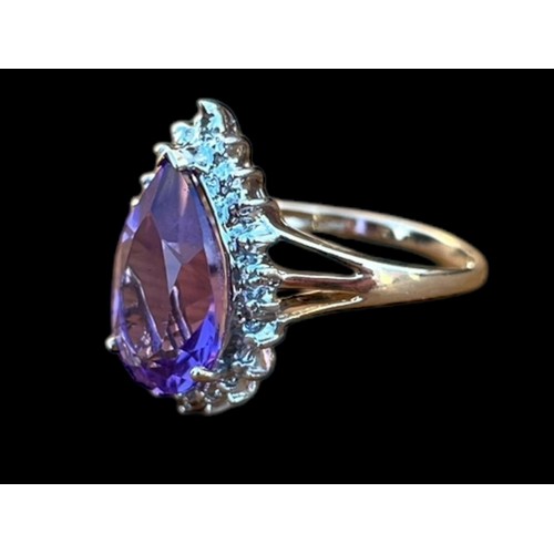 570 - A 9ct GOLD PEAR SHAPED AMETHYST AND DIAMOND CHIP RING