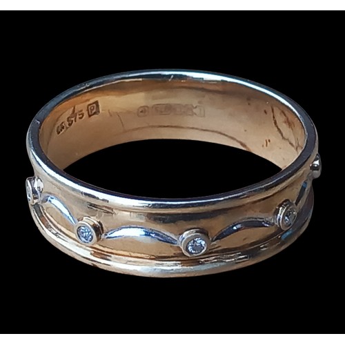 569 - A 9ct GOLD BAND WITH DOLPHIN AND WAVE PATTERN IN WHITE GOLD SET WITH 8 DIAMONDS 3.08grm