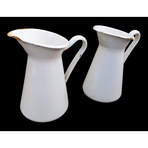 57 - A PAIR OF HEAVY ENAMEL JUGS