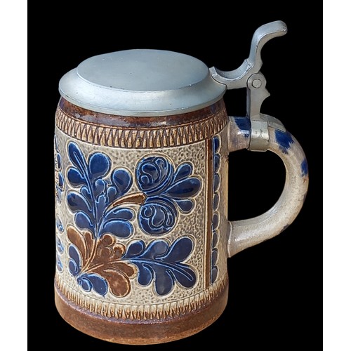 73 - A GERMAN POTTERY TANKARD WITH PLATED TOP