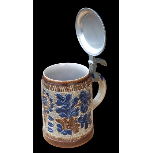 73 - A GERMAN POTTERY TANKARD WITH PLATED TOP