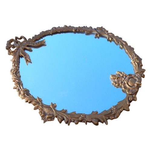 126 - AN ORNATE BRASS FRAMED MIRROR OF NEAT PROPORTION