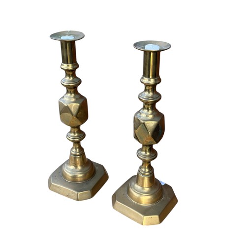 135 - A PAIR OF BRASS JACK OF DIAMOND CANDLESTICK