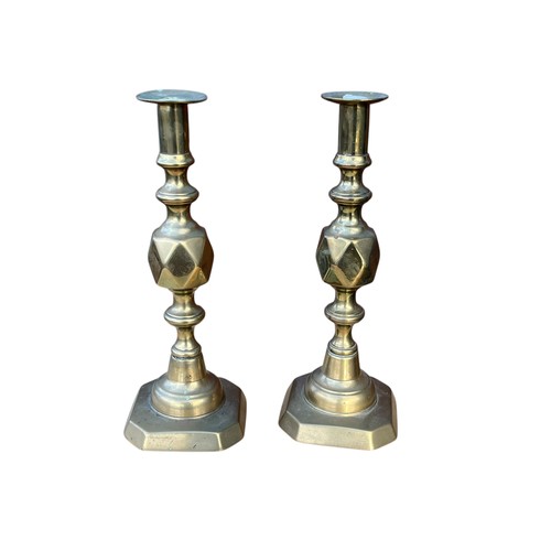 135 - A PAIR OF BRASS JACK OF DIAMOND CANDLESTICK