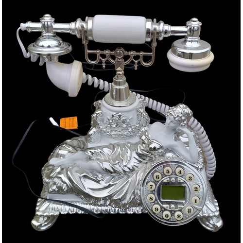 169 - A FIGURED TELEPHONE IN A WHITE AND CHROME FINISH