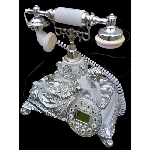 169 - A FIGURED TELEPHONE IN A WHITE AND CHROME FINISH