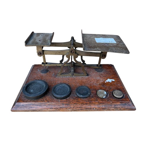 263 - A SET OF MOUNTED SCALES WITH WEIGHTS